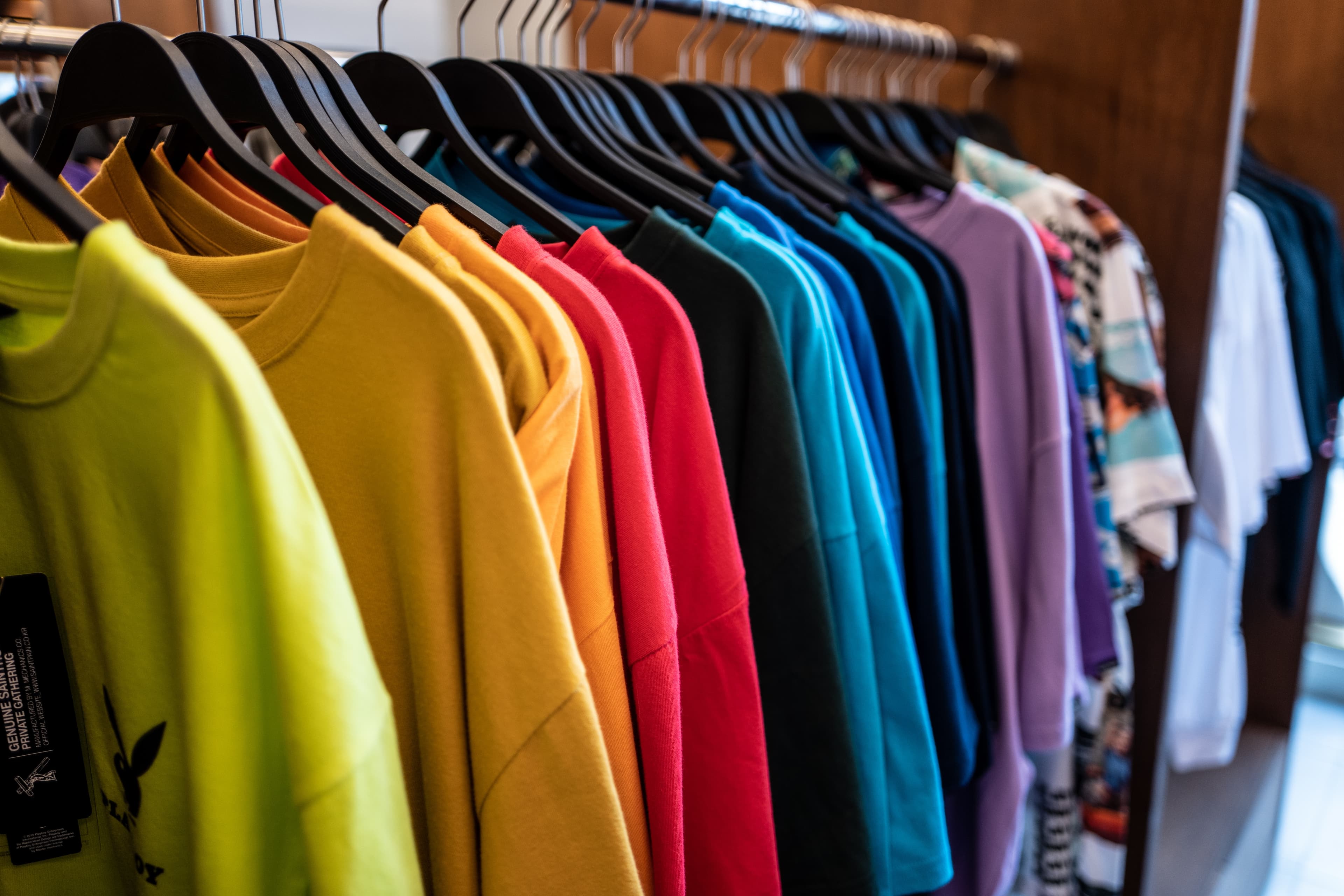 hanging colorful tshirts in wardrobe - background banner